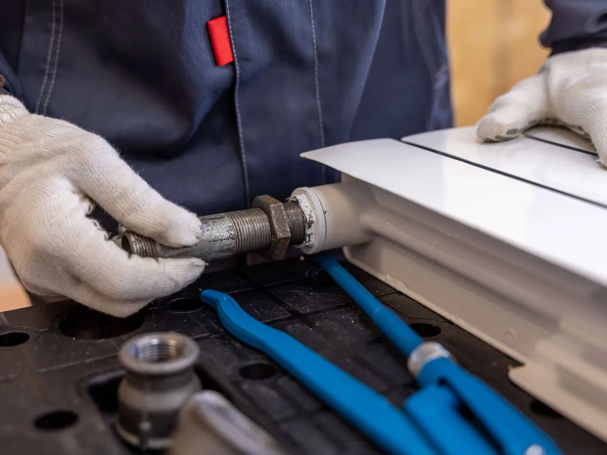 Indicative image of a radiator being installed. Not a photograph of an SG job.