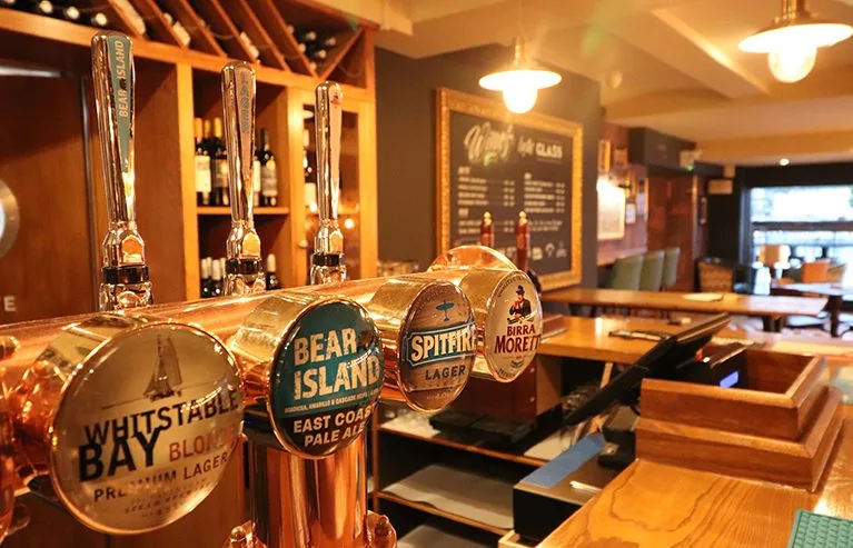 Indicative image of a pub bar with copper counter and timber back bar. Not a photograph of an SG job.