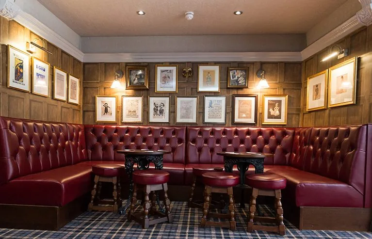 Indicative image of a panelled pub snug with buttoned leather seating. Not a photograph of an SG job.