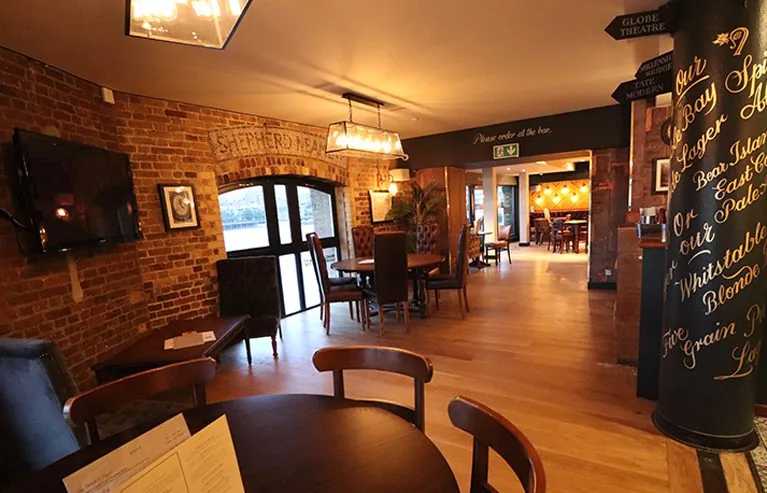 Indicative image of a pub dining room with exposed brickwork and timber floor. Not a photograph of an SG job.